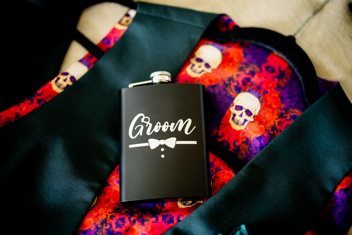 Black flasks with skull designs against a dark background with red and purple lighting effects.