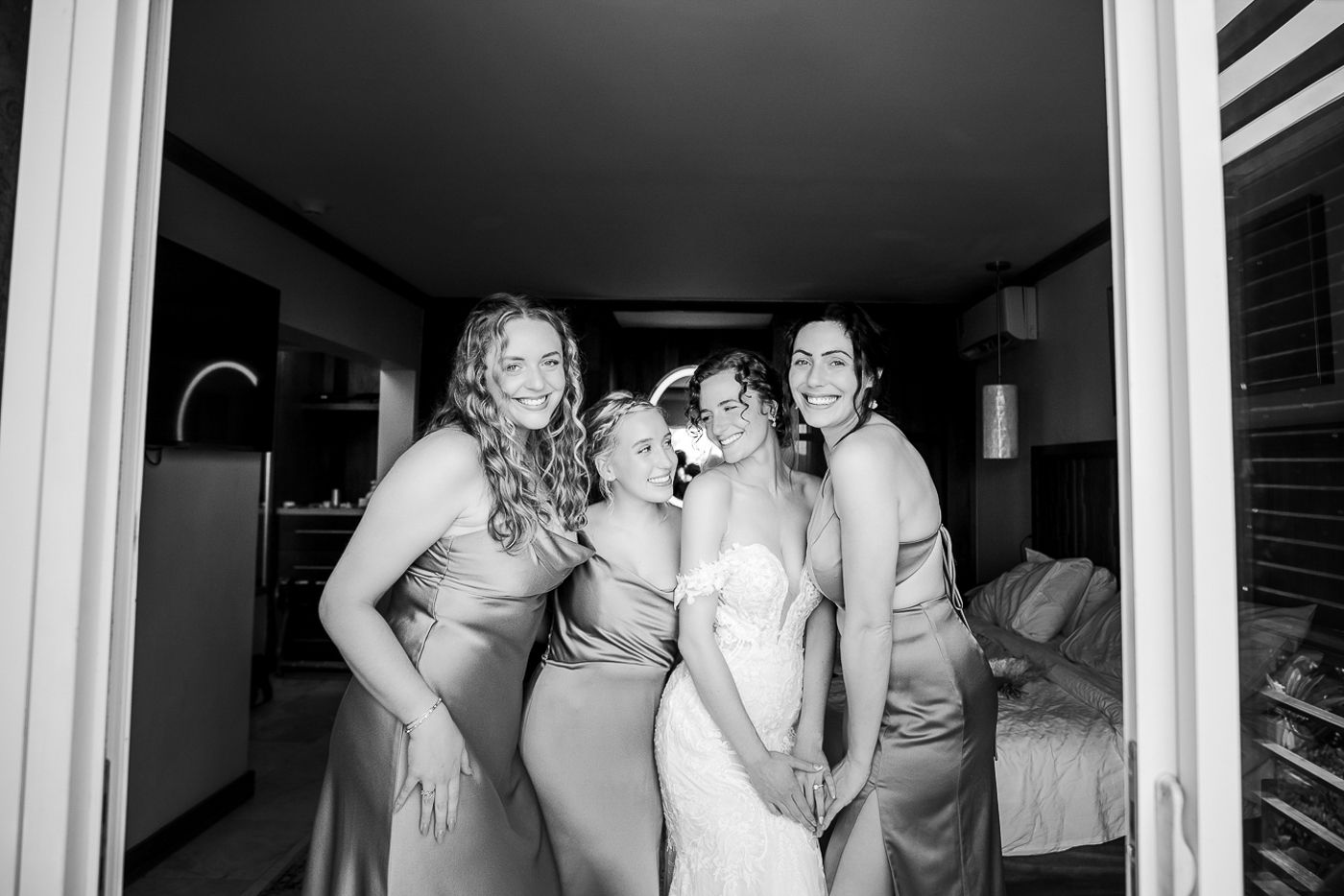 Black and white candid moments during wedding preparations in a bright indoor space.