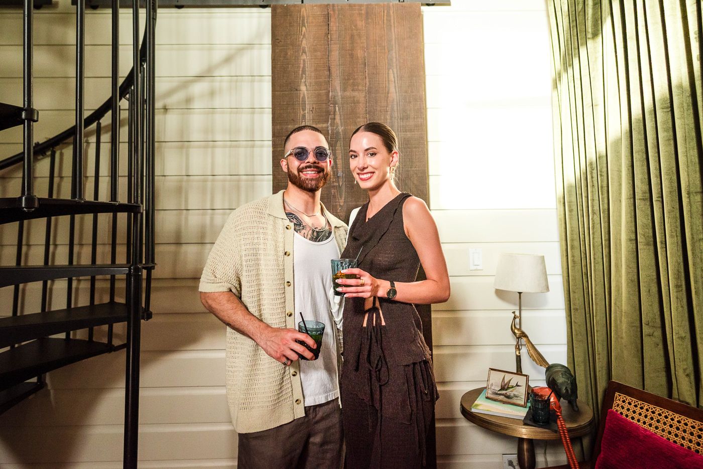 Dimly lit interior party scene with guests enjoying beverages and conversation.