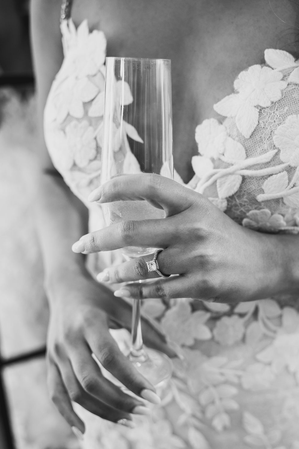 Hands delicately hold and reveal elegant white floral decorations in a series of black and white photographs.