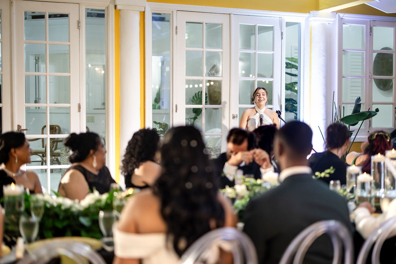 Indoor wedding reception venue with elegant decor and large windows.