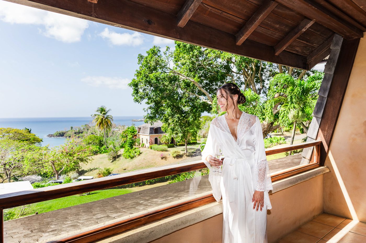Beautiful tropical ocean view from wooden terrace with palm trees.