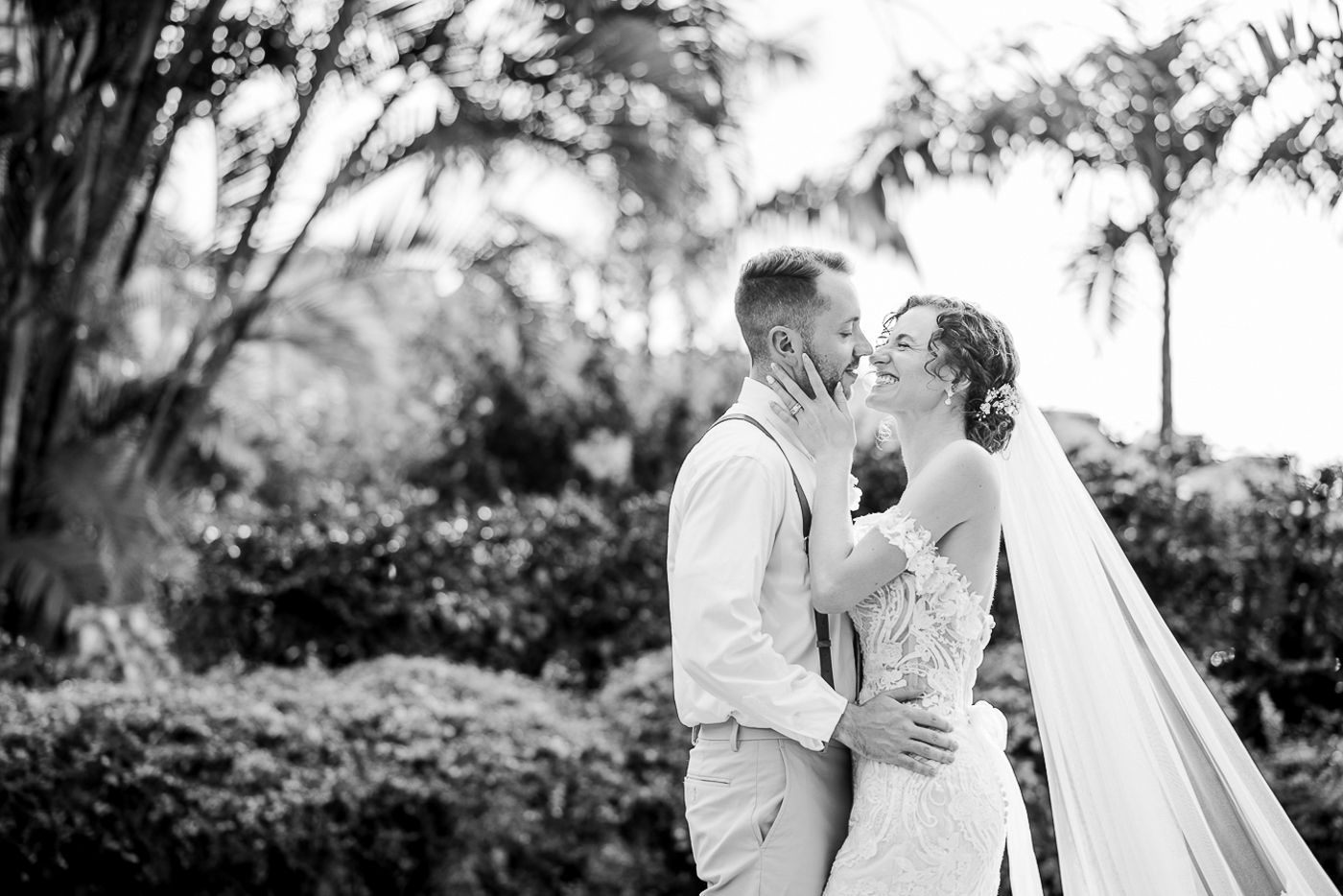 Black and white wedding portraits showing intimate moments in a tropical garden setting.