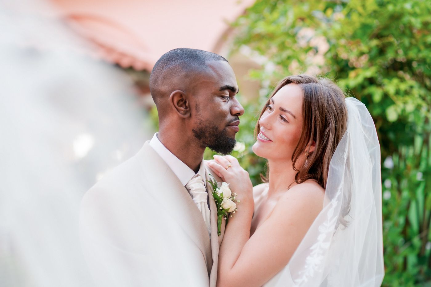 Close-up candid moment between couple during outdoor wedding photoshoot.