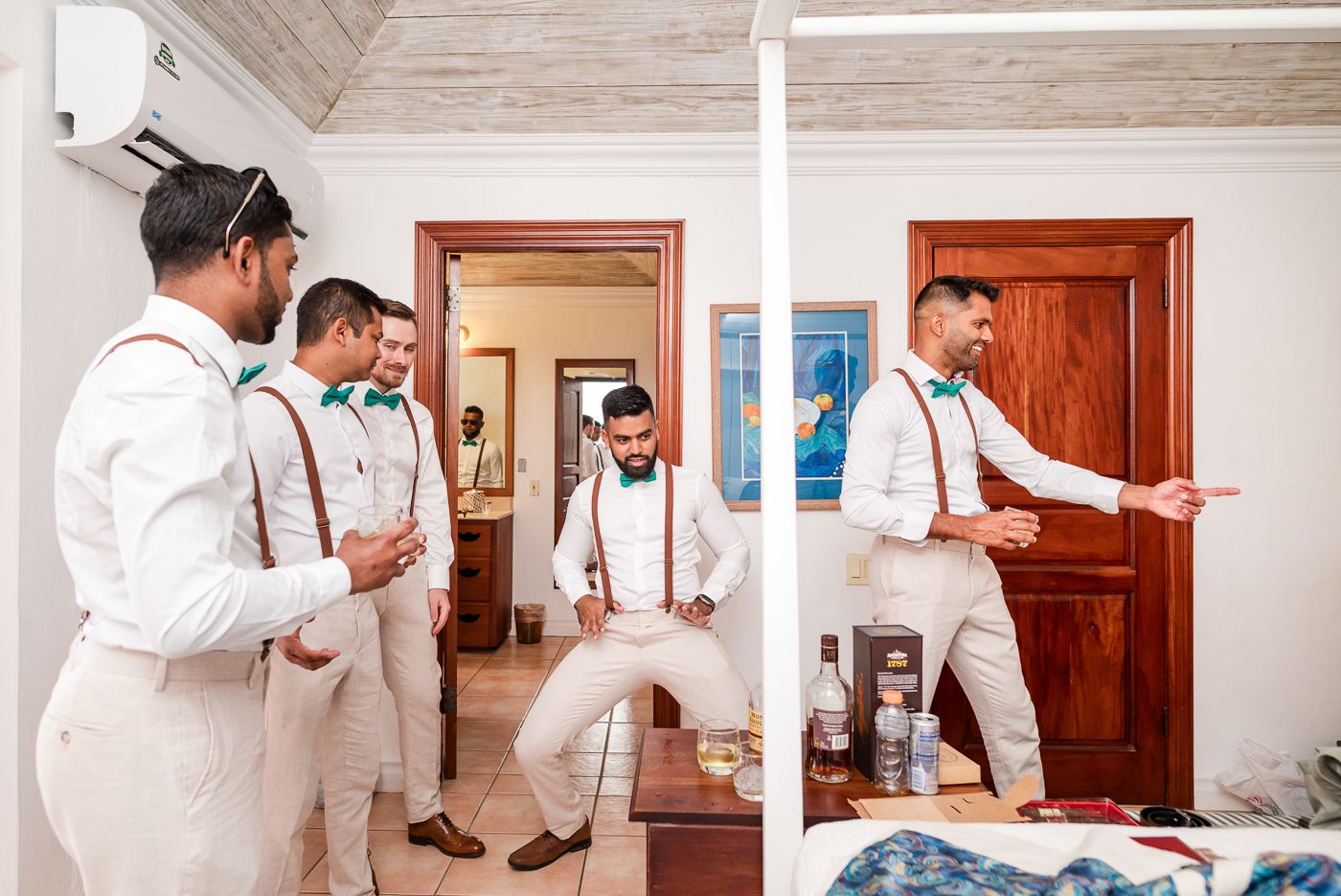 Group in formal white shirts and suspenders preparing for event.
