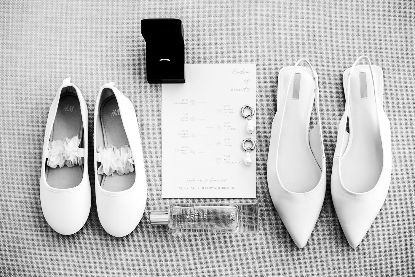Collection of elegant white bridal shoes arranged in a row on gray linen background.