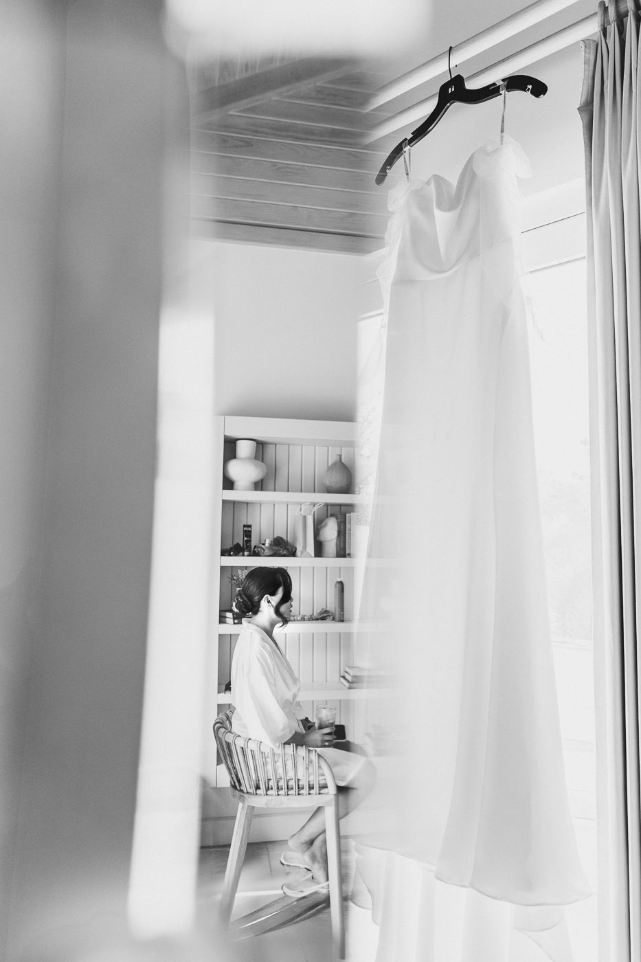 Clean white interior room with modern shelving and natural light.