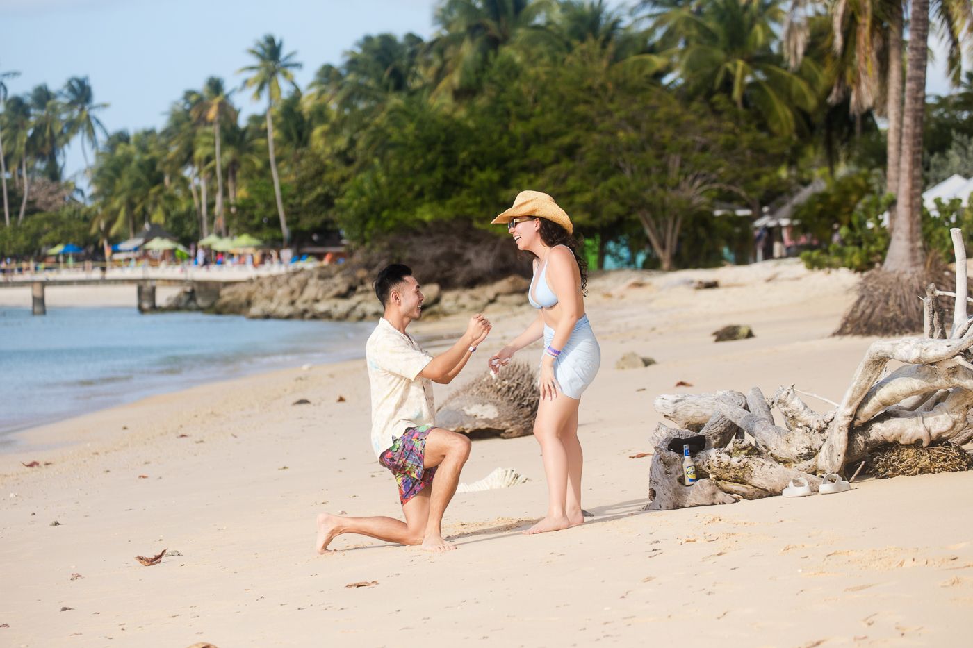 Scenic beach photography series showing a romantic moment among palm trees and sand.