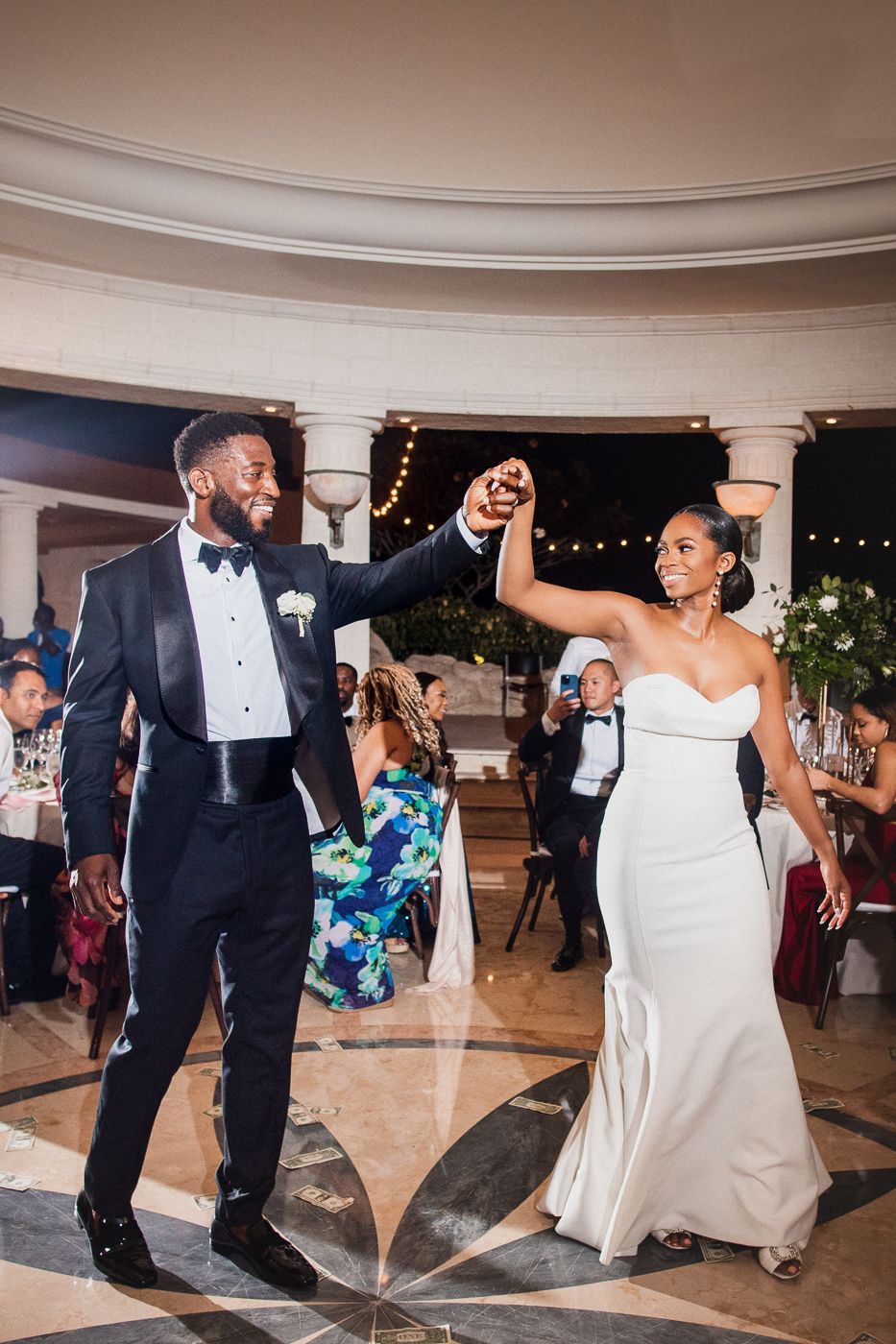 Wedding reception dance party showing guests enjoying themselves on an elegant dance floor with decorative columns.