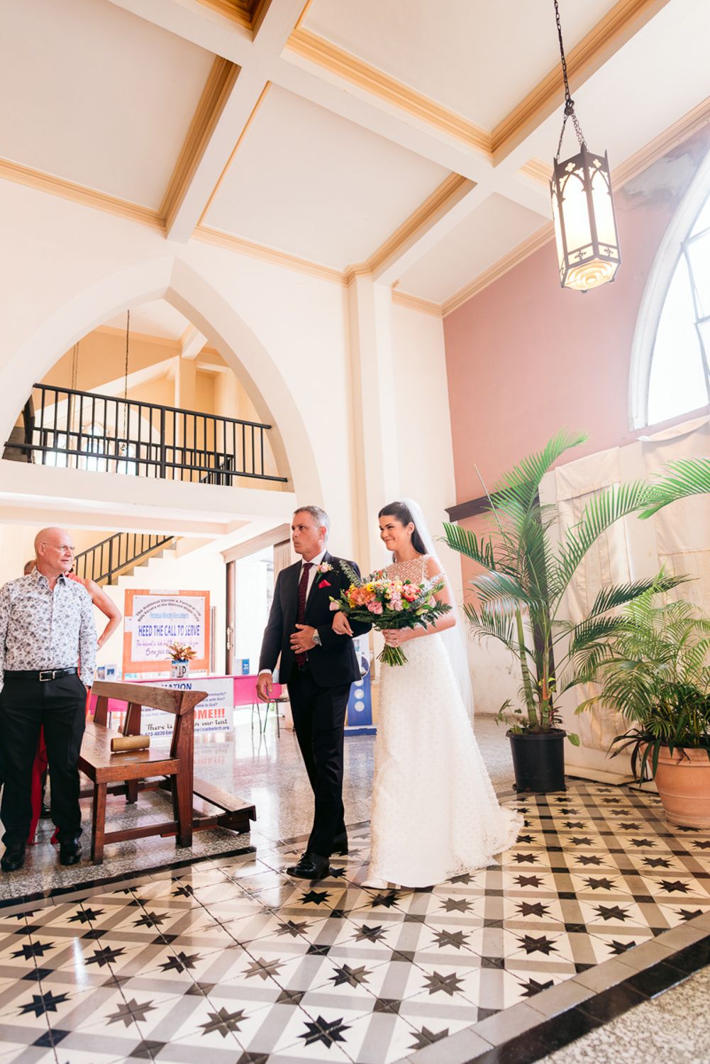 Series of wedding moments captured in a grand venue with black and white checkered floors and elegant palm decorations.
