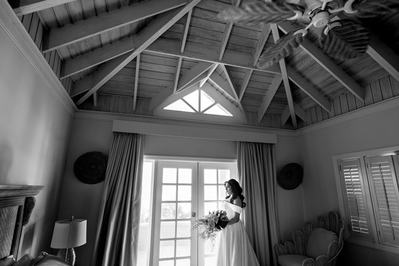 Interior architectural detail showing vaulted ceiling and windows in a bright room.