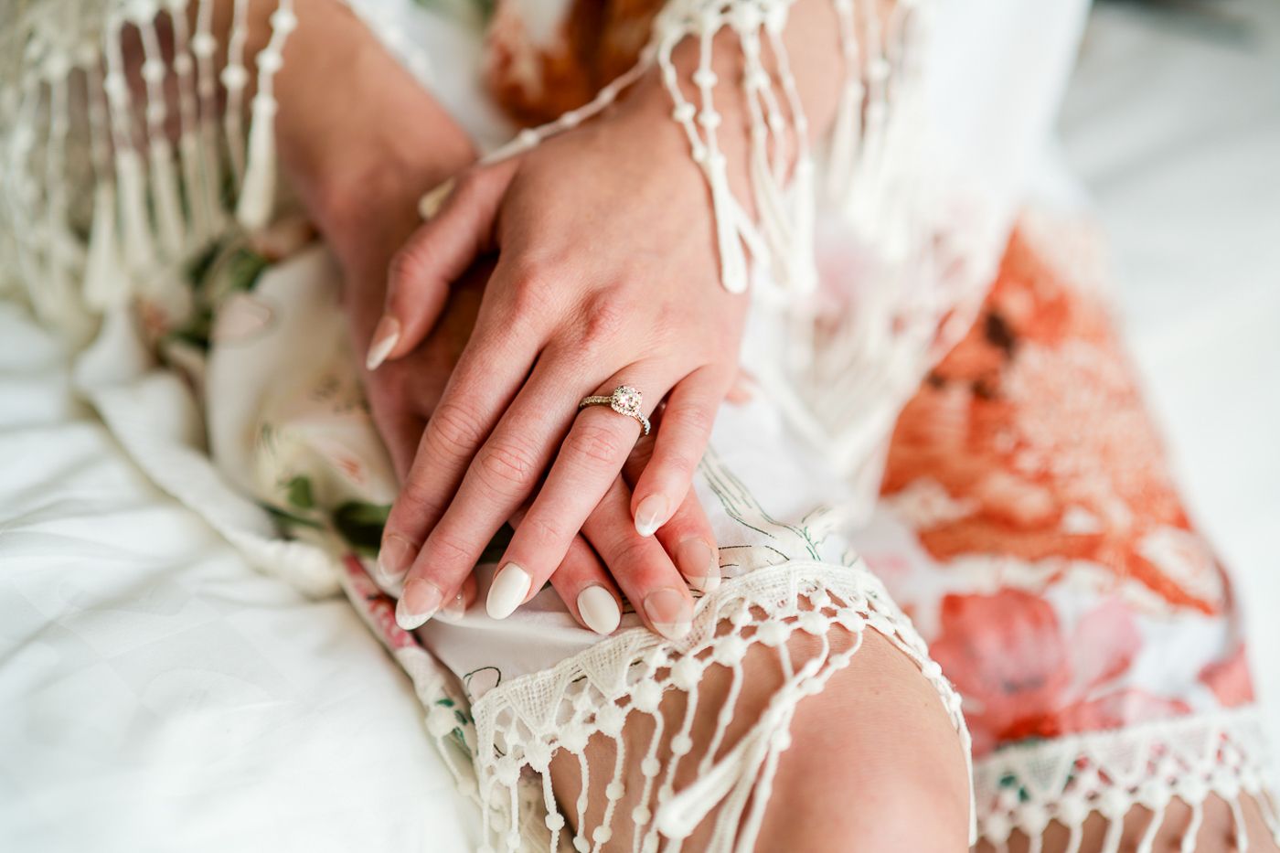 Close-up of delicate lace details on a white wedding dress.