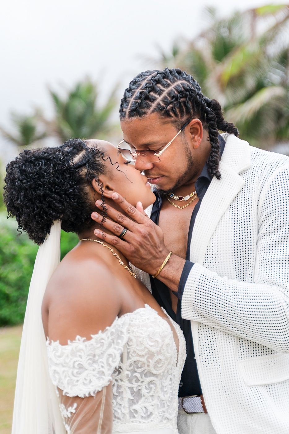A tender moment captured between a couple on their wedding day in a tropical setting.