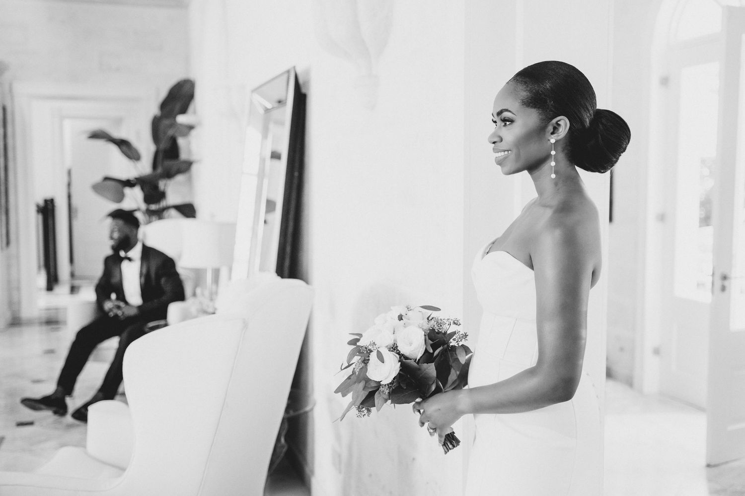 Elegant wedding day candid shots in white hallway showing couple and guests in formal attire.
