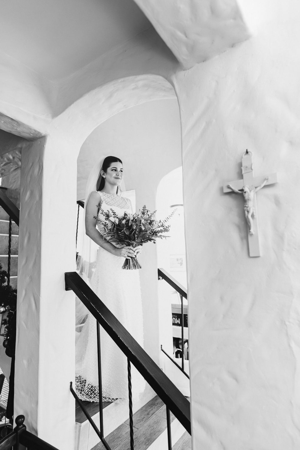 A series of white arched hallways and doorways with stairs and plants, creating an architectural interior perspective.