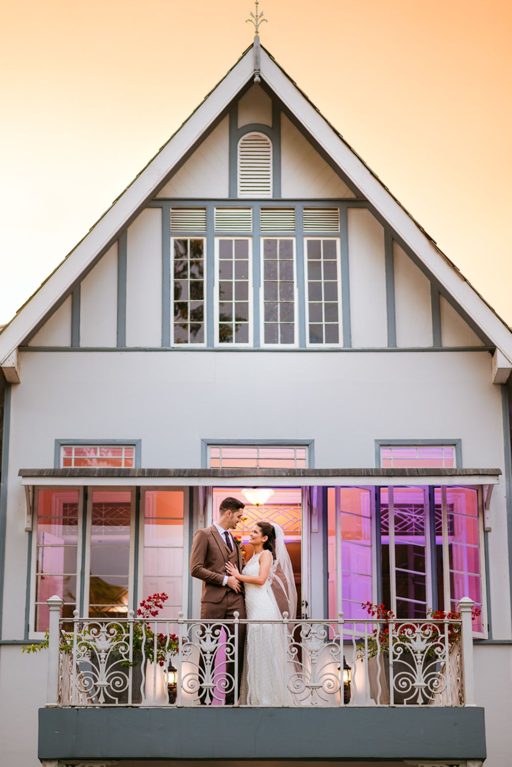Sequence of wedding photos showing romantic couple poses on venue balcony with pink and purple uplighting.