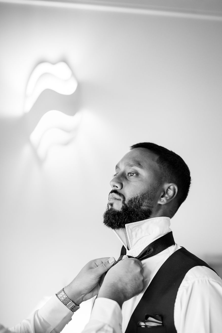 Artistic black and white portraits showing preparations before a formal event.