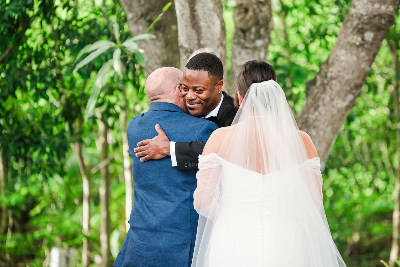 Intimate wedding moments captured on a path surrounded by tropical landscaping.