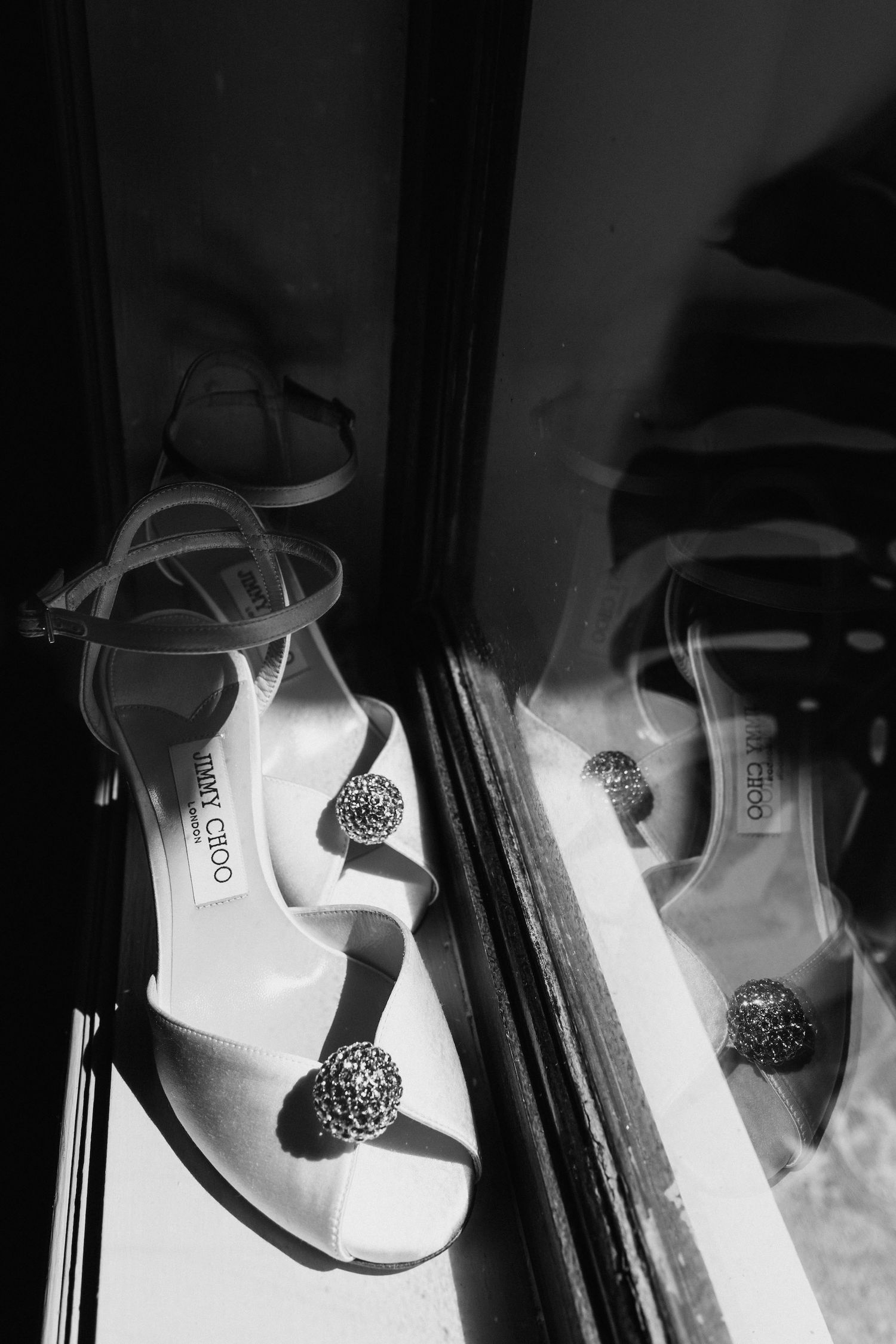 Artistic black and white detail shot of wedding jewelry and accessories.