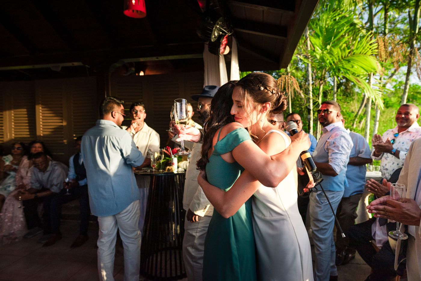 People socialize and mingle at a tropical outdoor wedding reception venue.