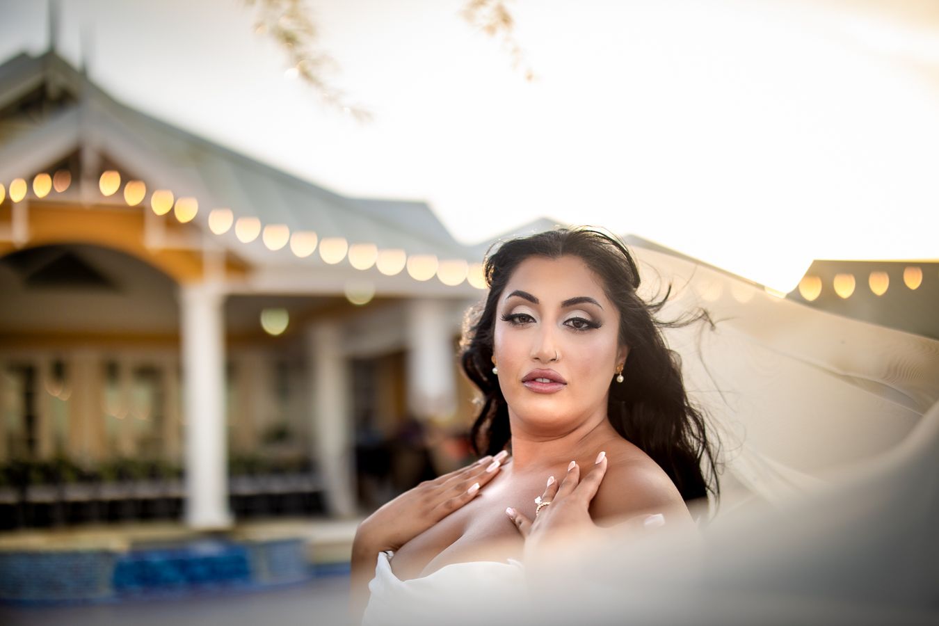 Romantic sunset wedding photography session with dramatic lighting and elegant poses.