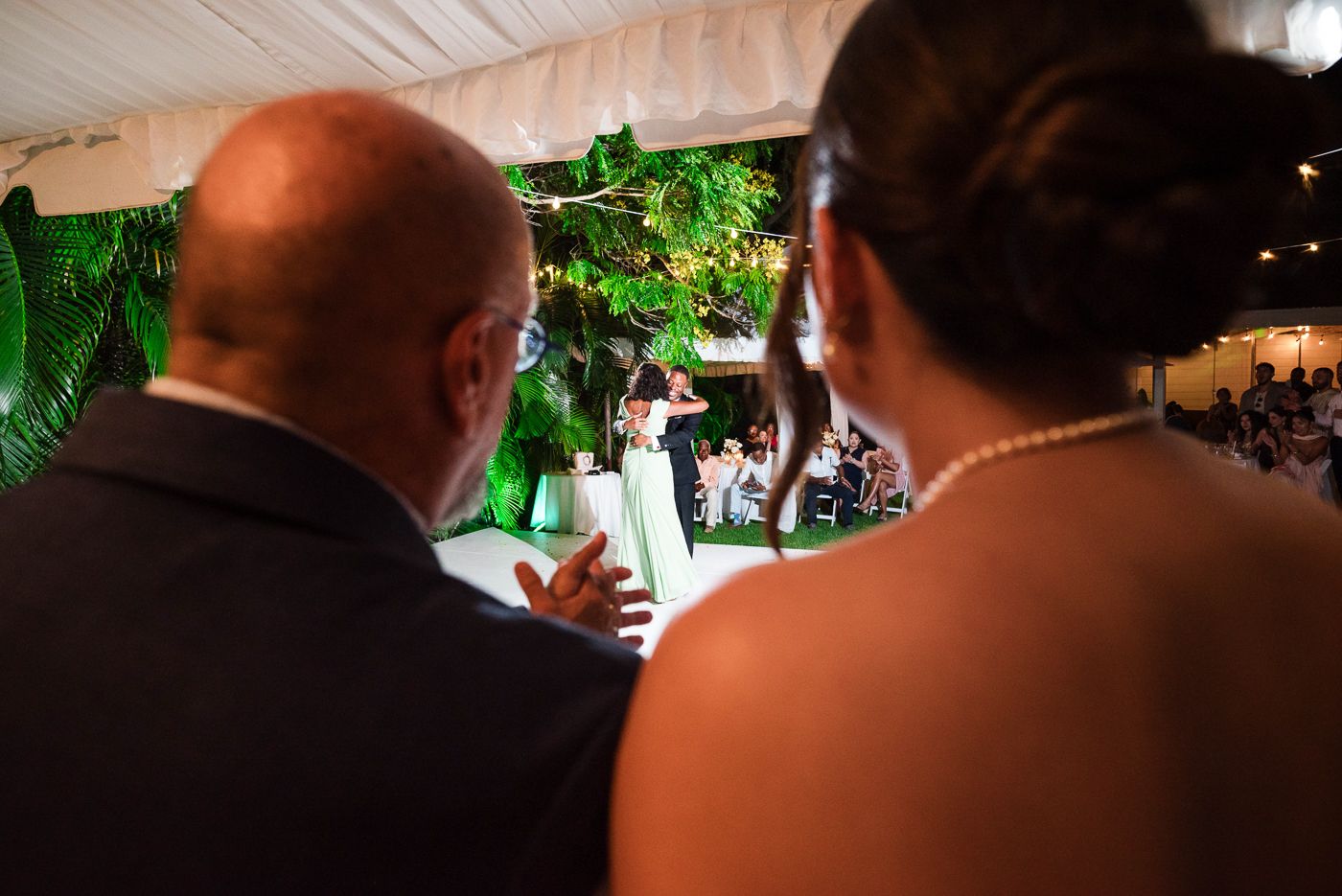 Guests mingle under draped fabric ceiling at an elegant indoor wedding reception.