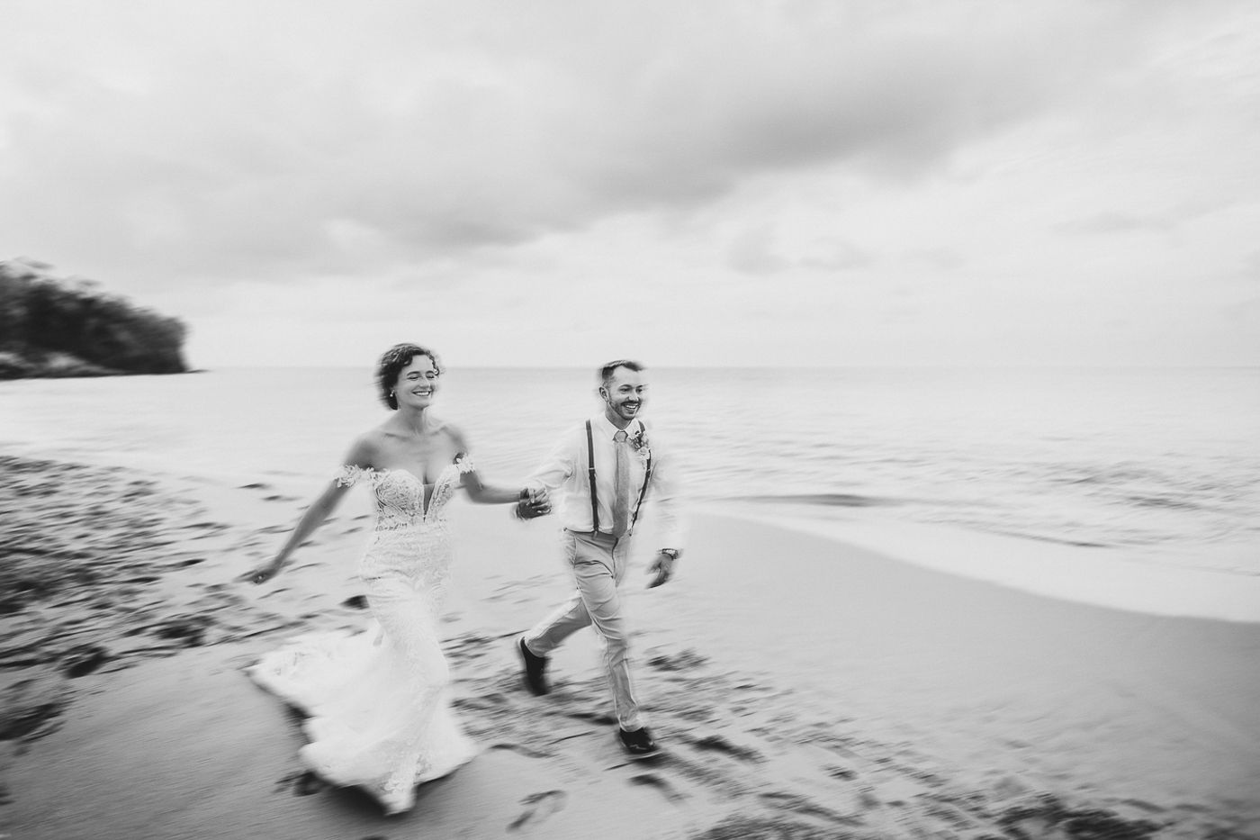 Black and white photograph of a joyful moment on a beach.