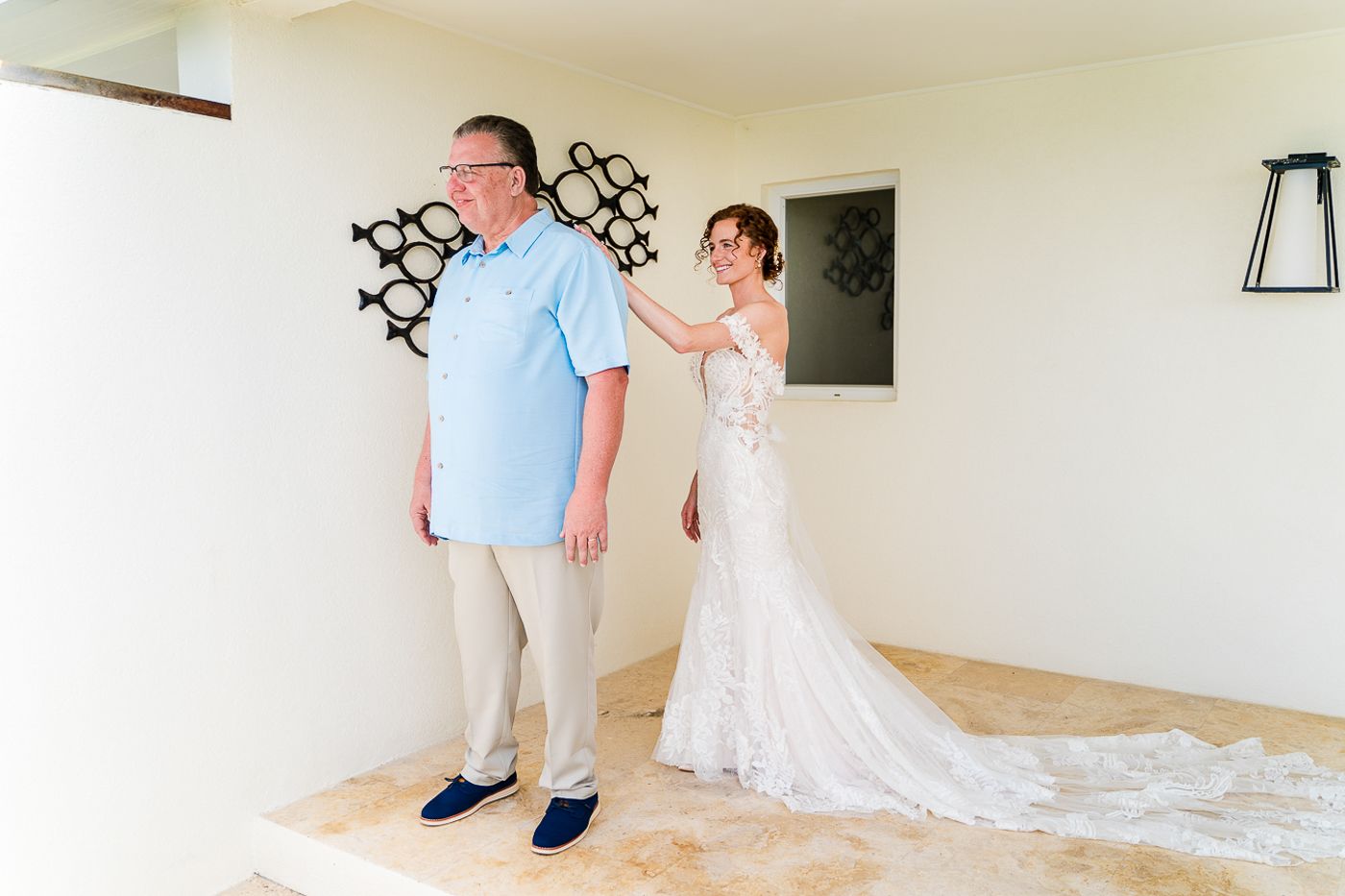A first look moment before the wedding ceremony in a bright interior space.