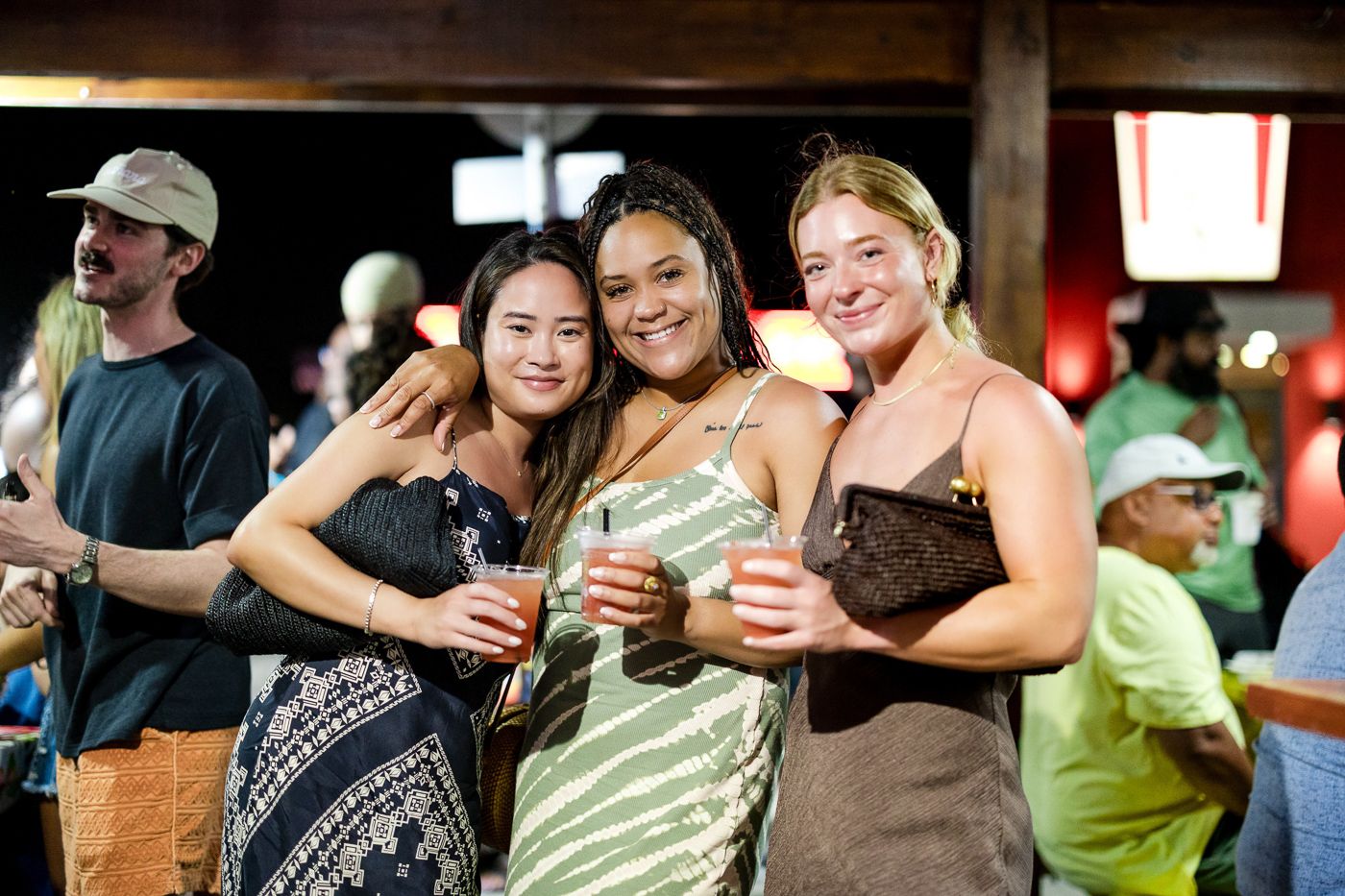 Group enjoying drinks together at outdoor social gathering.