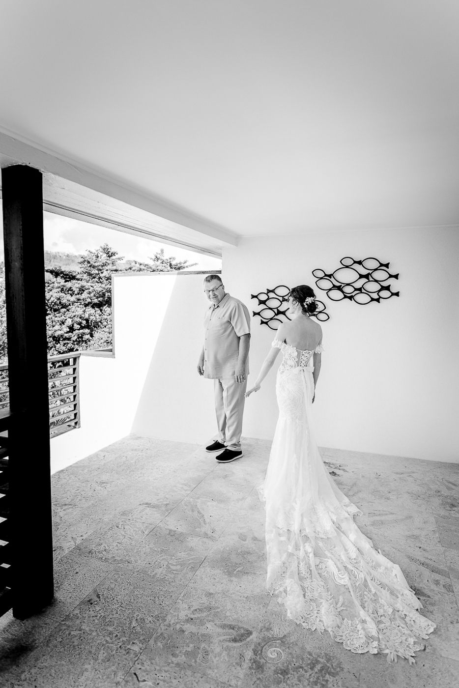 Black and white photo series showing the sweep of a wedding dress train in an elegant hallway.