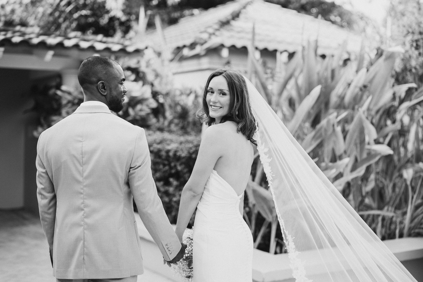 Black and white photographs showing couple walking through garden pathways.