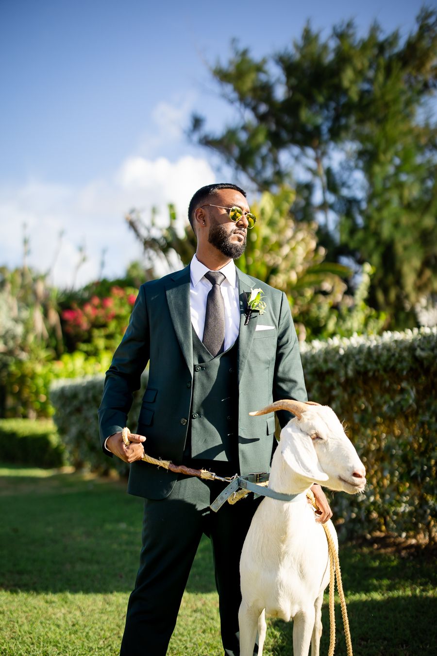 Artistic wedding portraits taken outdoors featuring formal attire against lush garden backdrop.