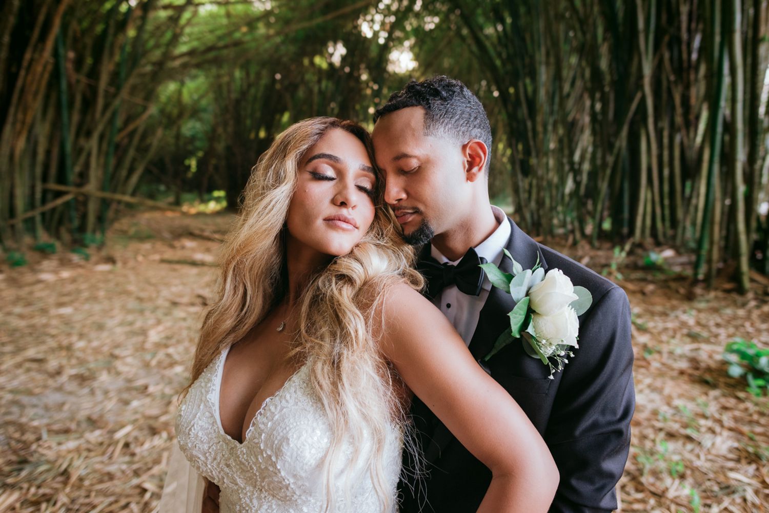 A romantic wedding couple shares an intimate moment together in a bamboo forest setting. Trinidad wedding photography