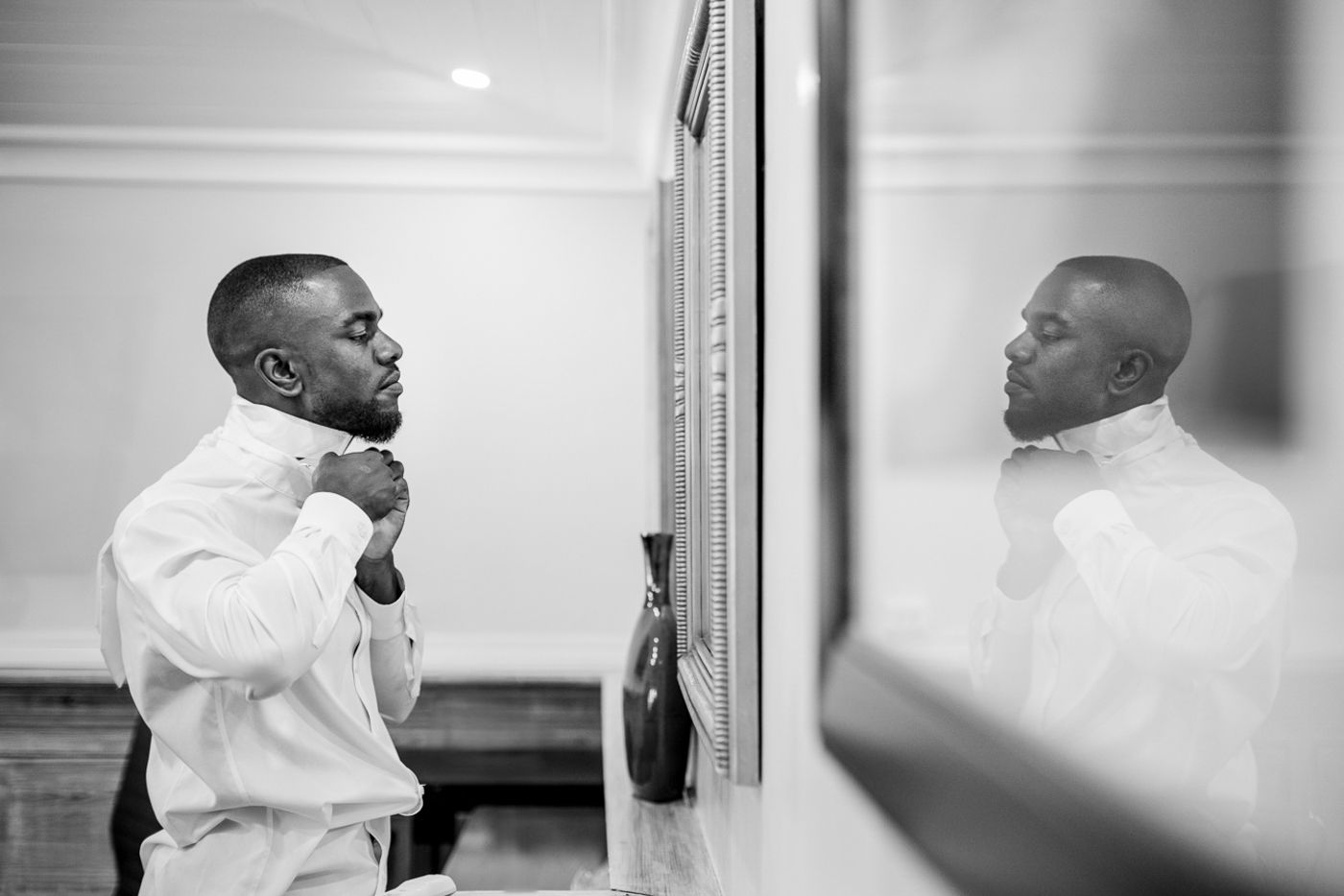 Black and white photos capturing candid moments during wedding preparations.