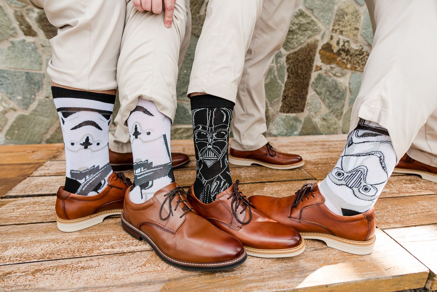 Close-up of groomsmen wearing Star Wars themed socks with brown leather dress shoes.