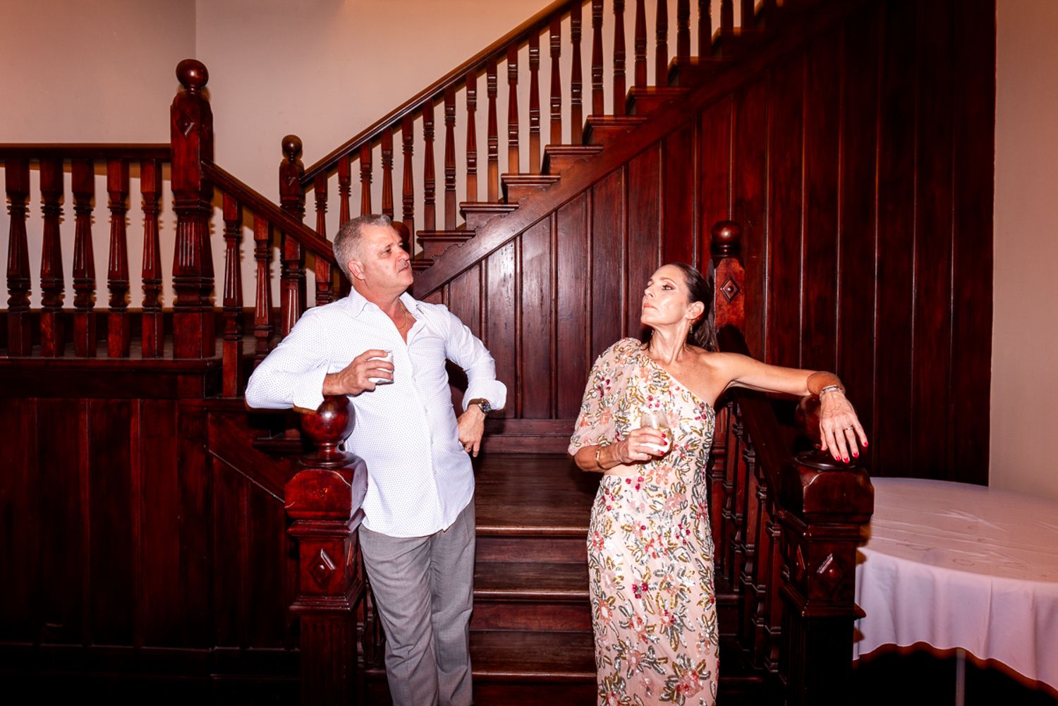 A sequence of candid photos showing people having fun while dancing and interacting on a vintage wooden staircase.