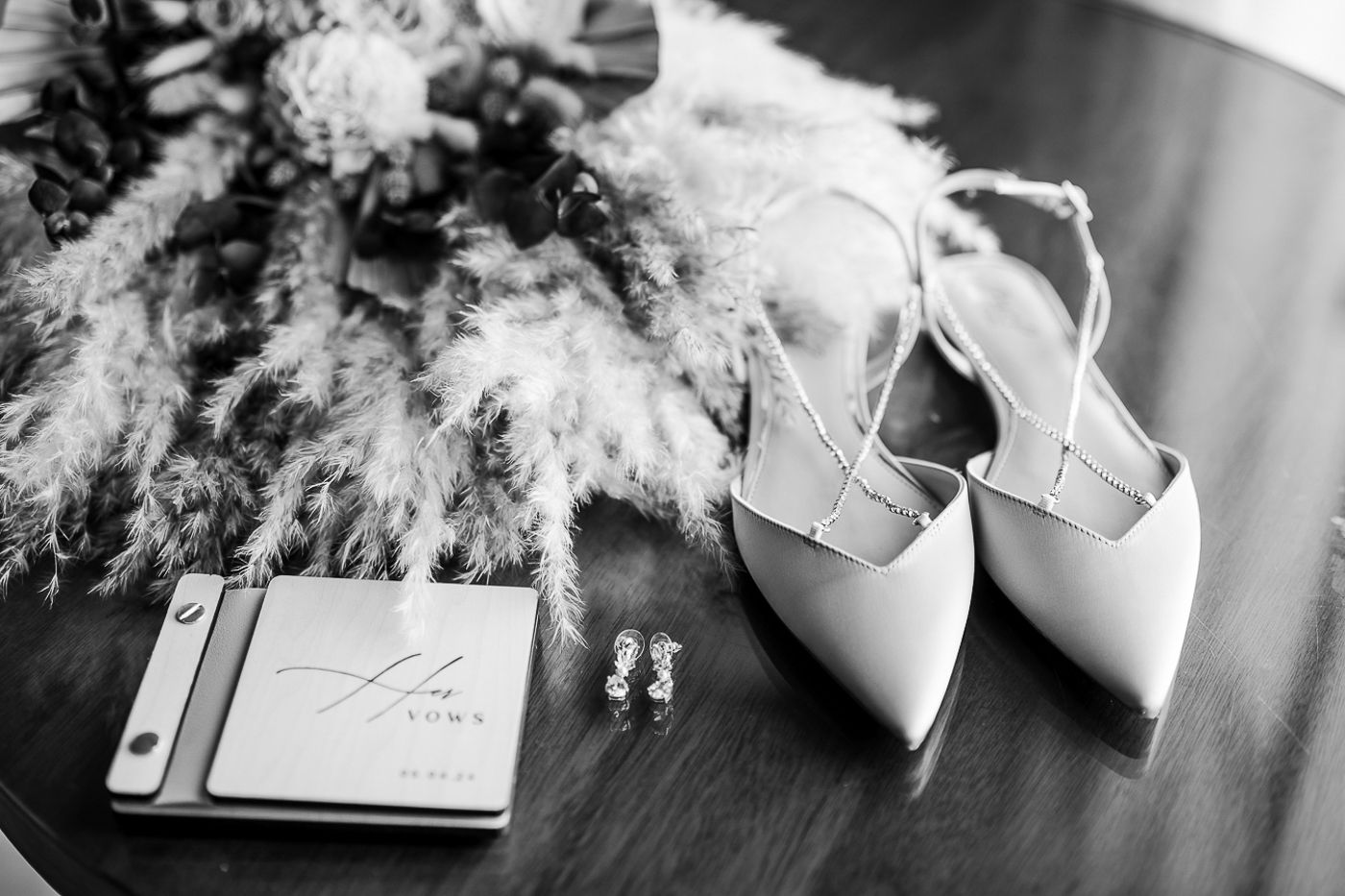 Wedding accessories and details arranged in black and white photography.