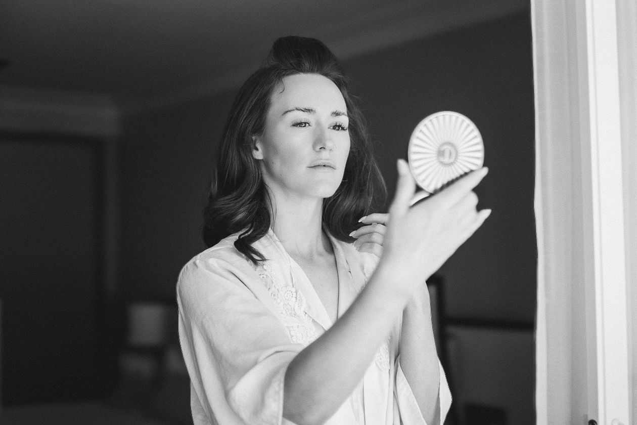 An intimate black and white wedding photography session with dramatic lighting.