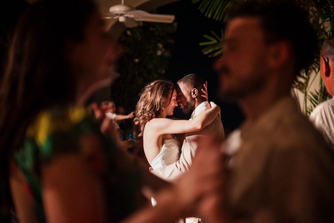 An intimate dance moment captured between couples at an evening reception.