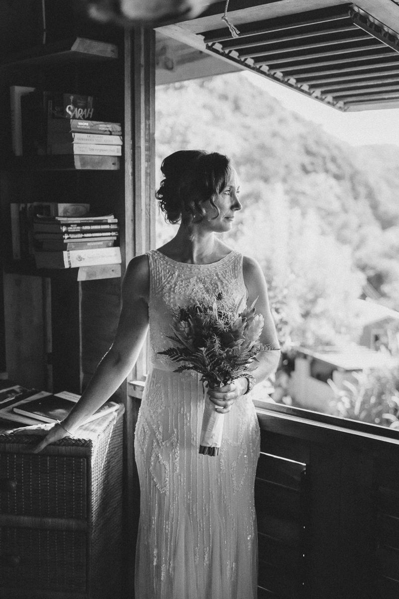 Elegant black and white wedding portrait with a vintage-inspired beaded dress and natural window lighting.