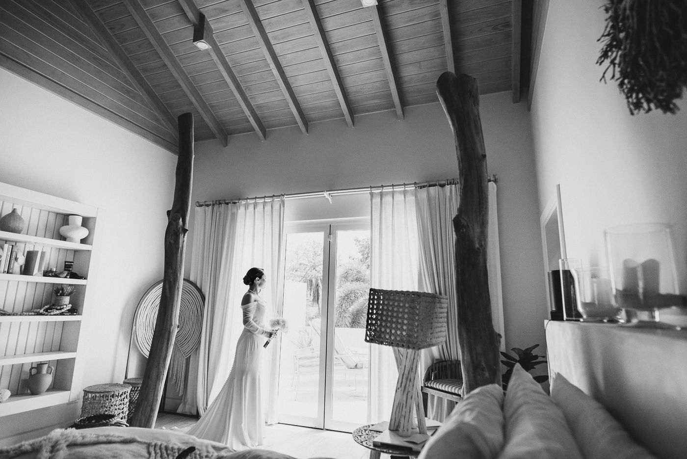 Black and white interior shots showing a modern room with slanted wood beam ceiling.