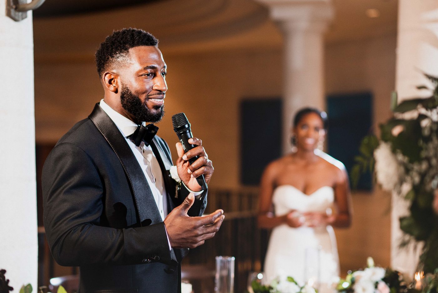Wedding speeches and toasts being delivered during an elegant indoor reception.