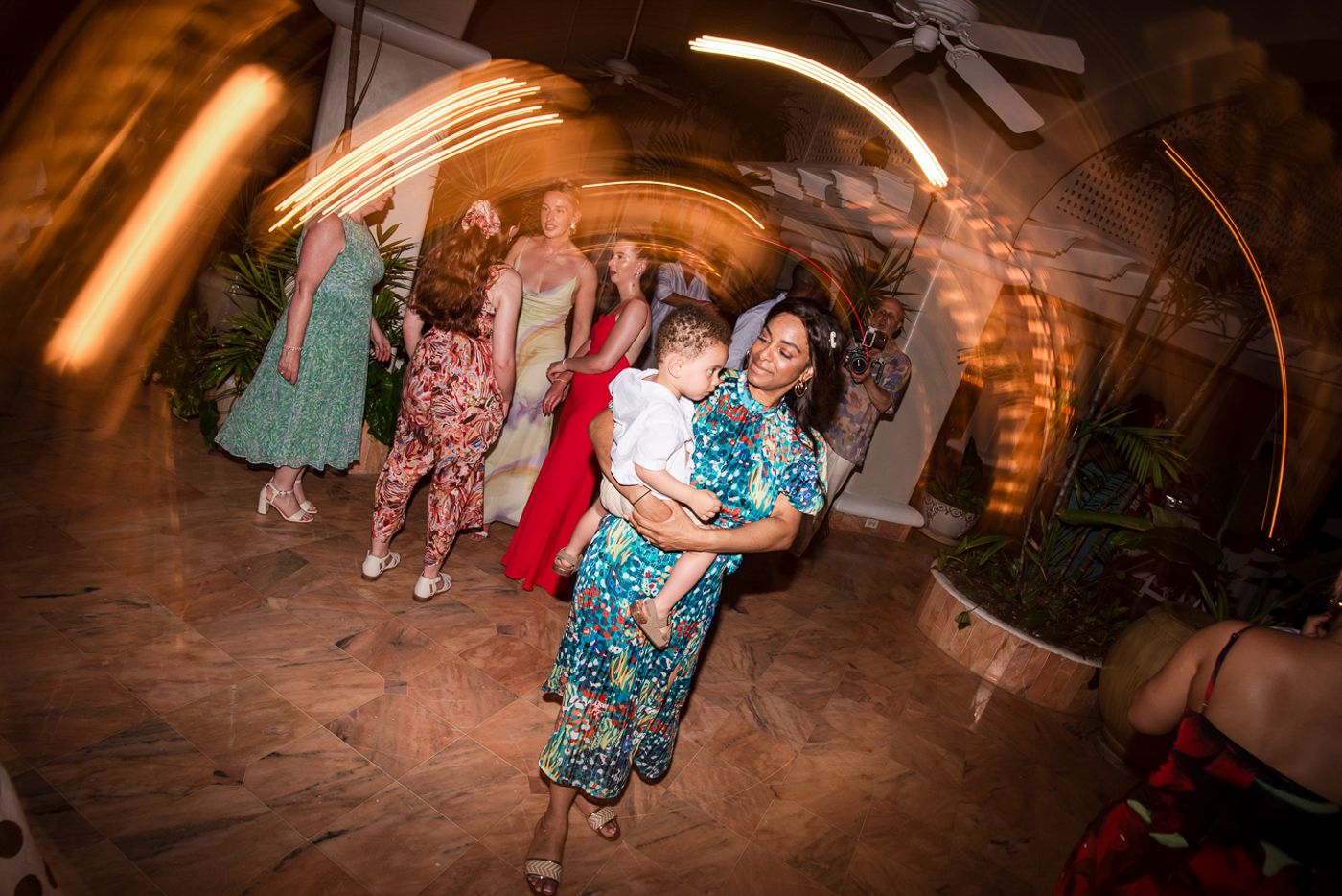 Wedding reception dance party captured with a dynamic tilted camera angle in an indoor venue.