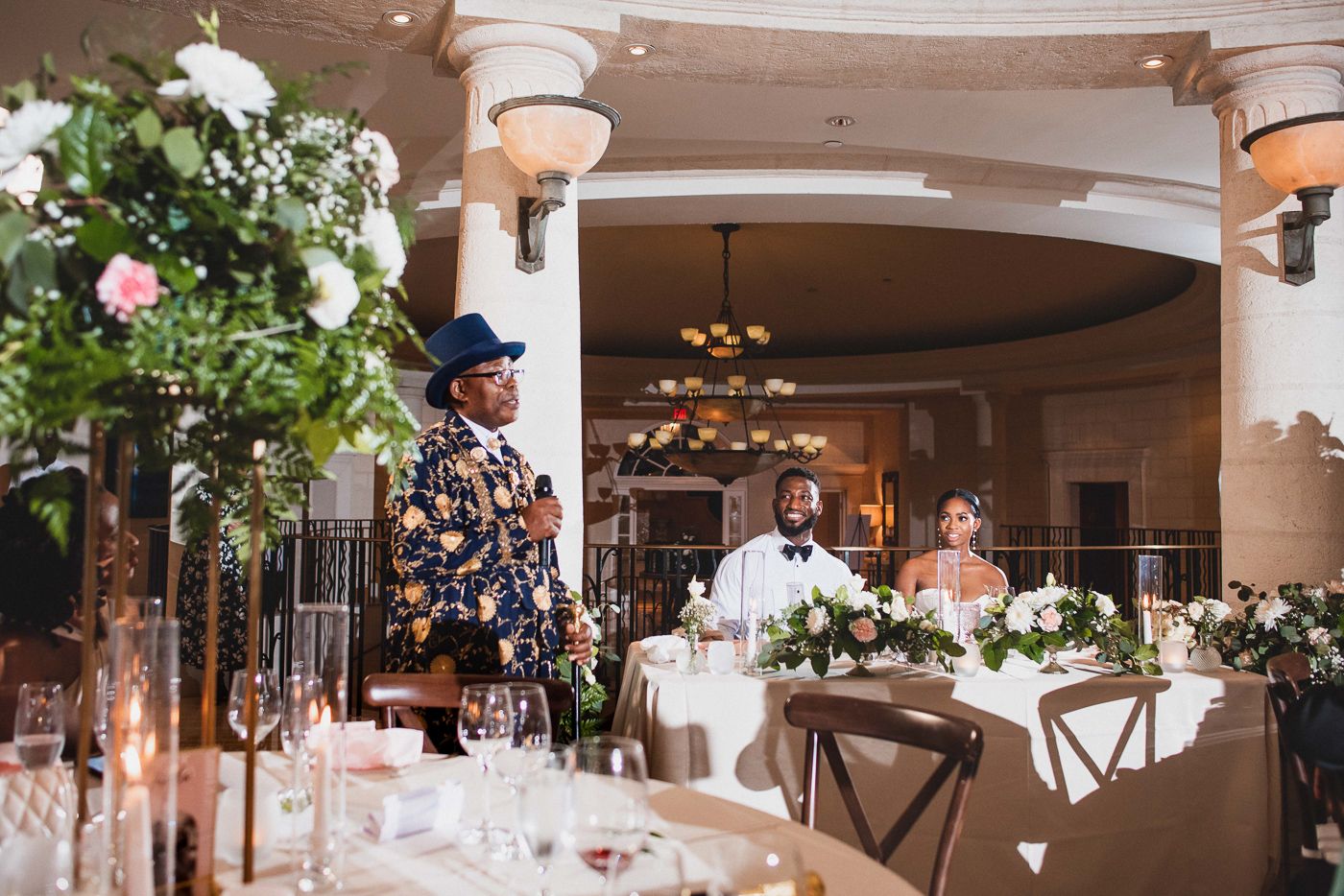 Elegant wedding venue decorated with white floral arrangements and string lights creating a romantic atmosphere.