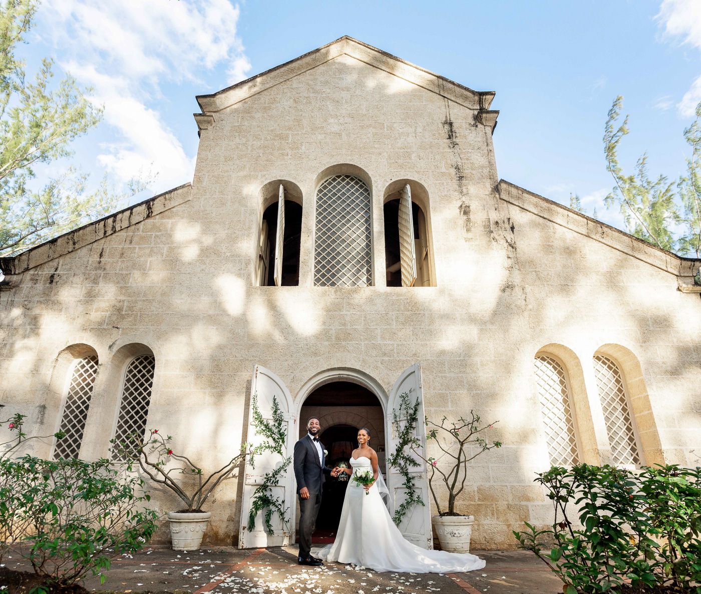Wedding photographers Celeste and Reece documenting the couple outside St James Parish Church in Barbados, black luxury wedding photography.