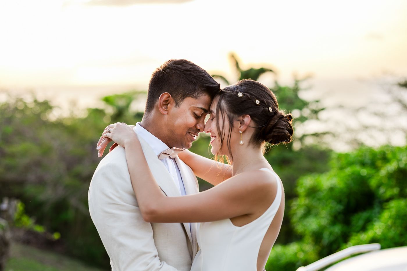Couple shares intimate moment on stone terrace during sunset.
