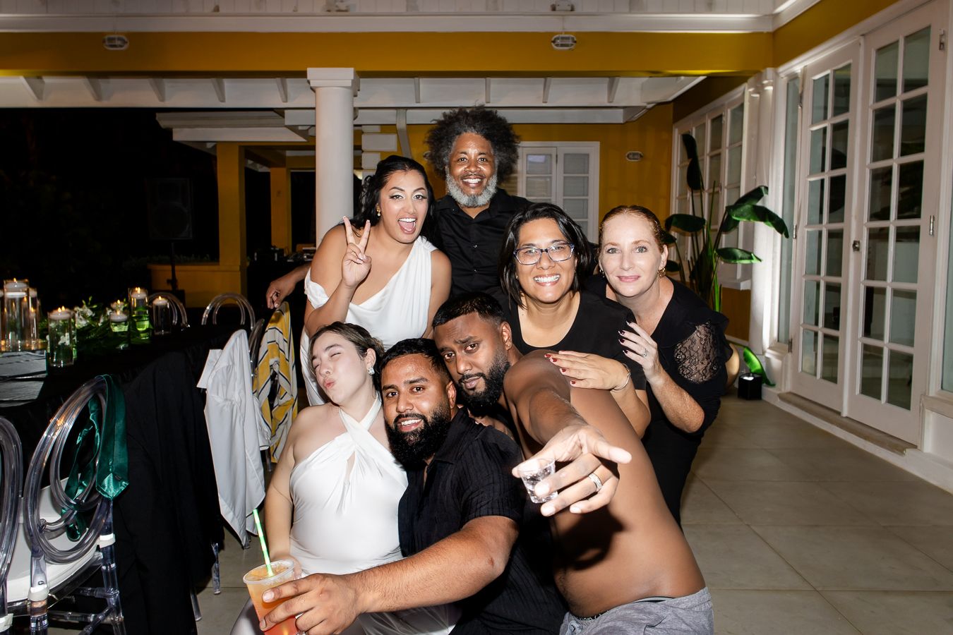 Group photo of wedding party members posing together indoors.