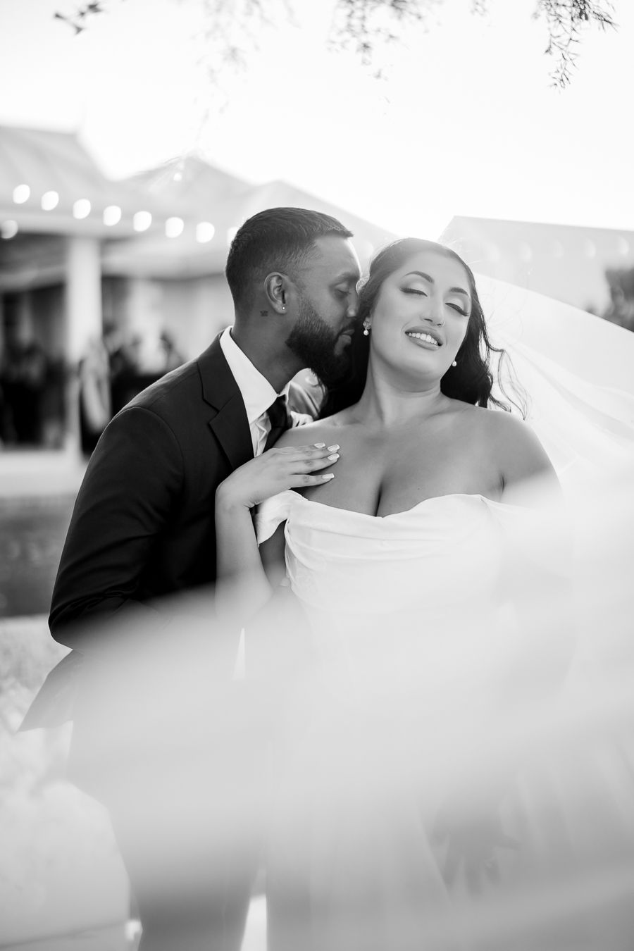 Black and white intimate wedding portraits showing tender moments through flowing veil.