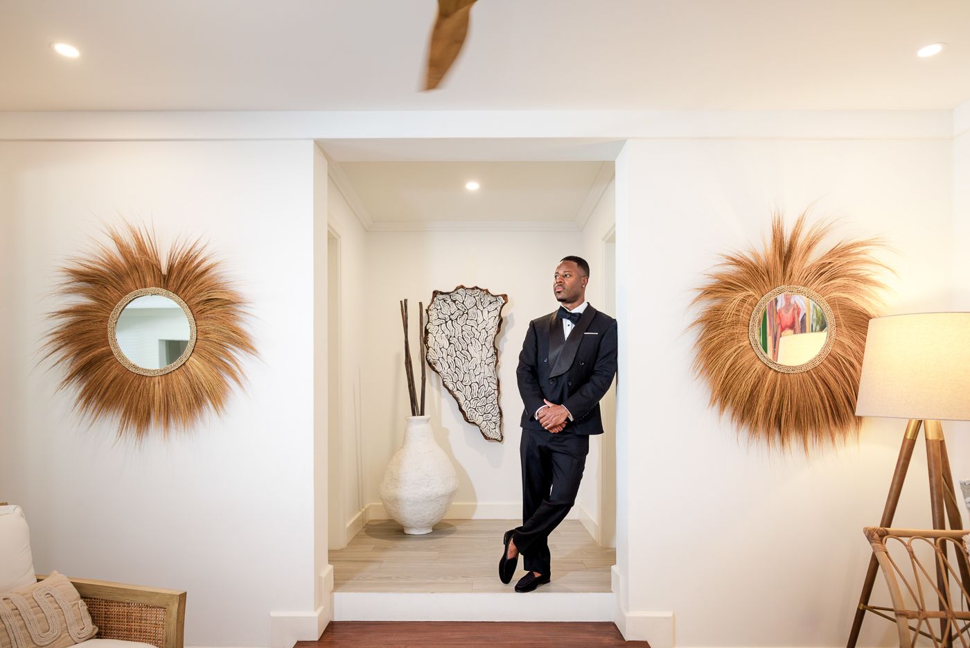 Modern interior with sunburst mirrors and formal event preparations.