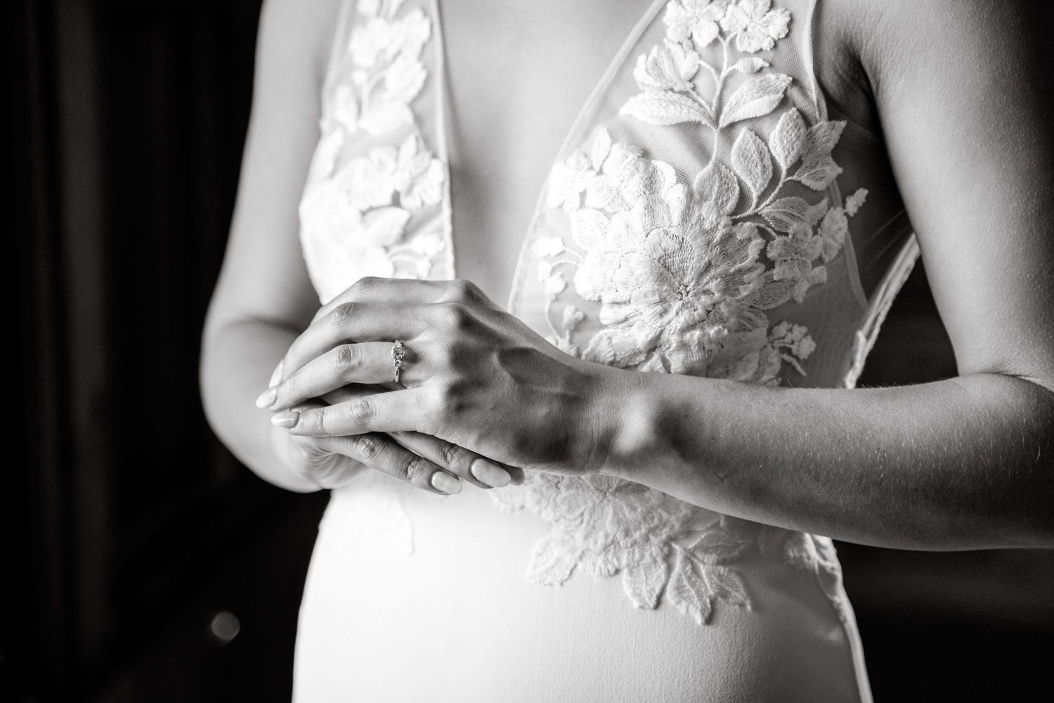 Close-up details of a lace wedding dress bodice in black and white.